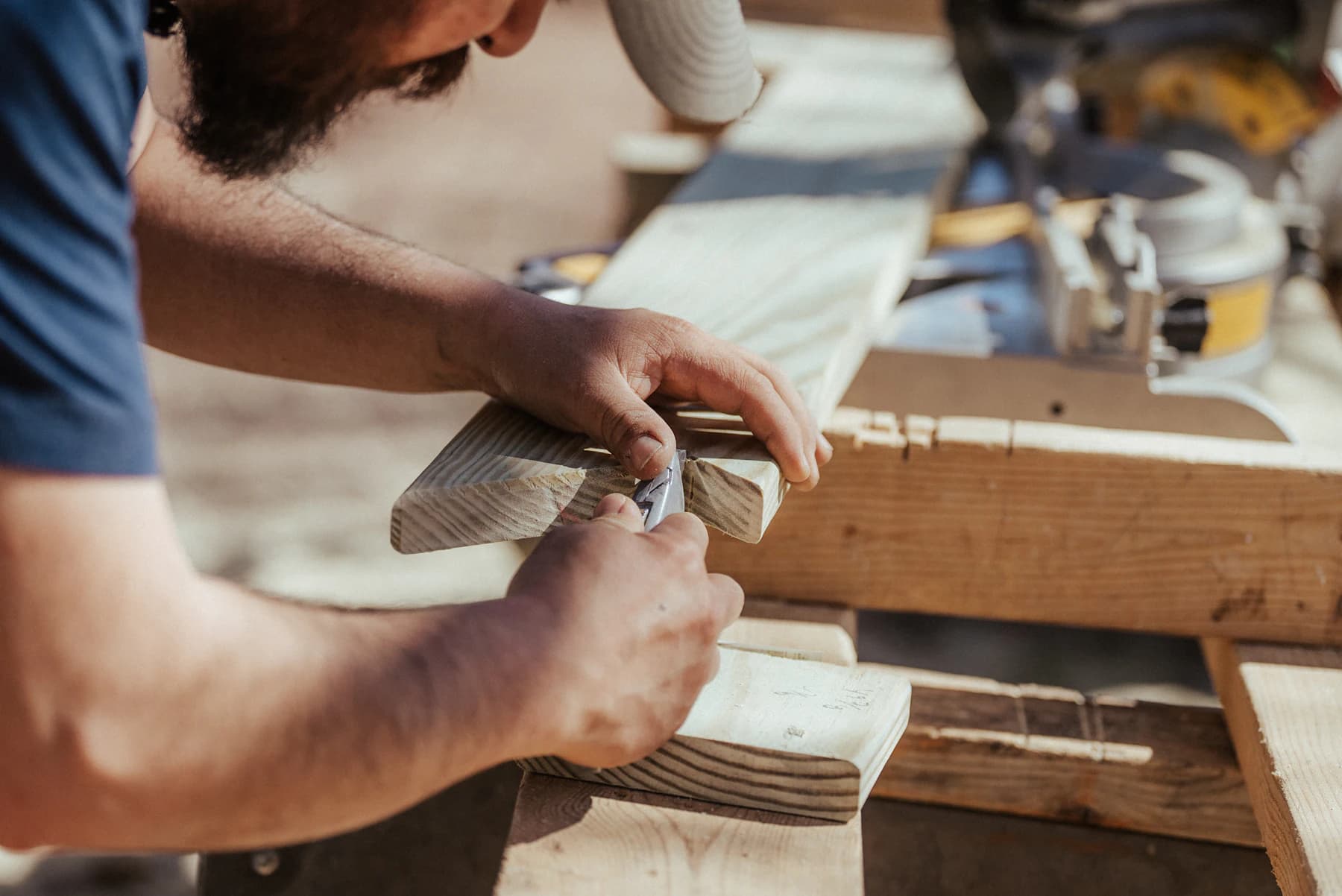 Contractor carefully shaping wood for a custom build